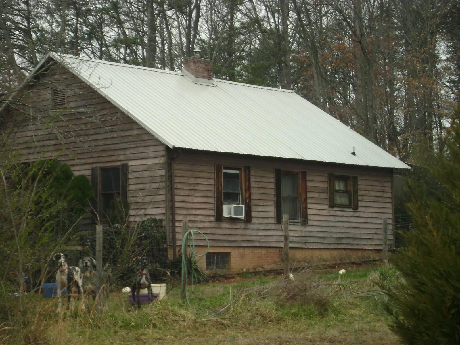 White metal roof on an old wood sided farmhouse, from a Metal Roof Installation job in New Haven